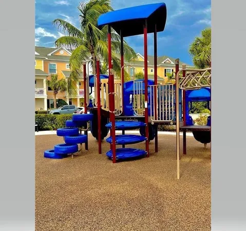 a front view of a multi story residential apartment building with yard and green space