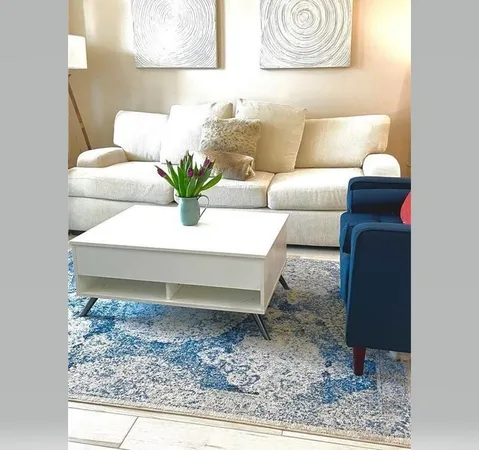 a living room with furniture and a rug