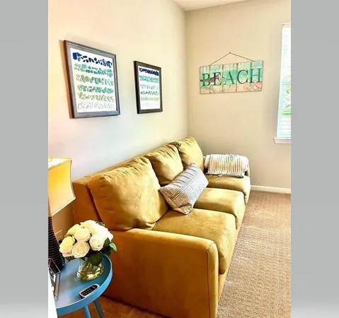 a living room with couch and painting on the wall