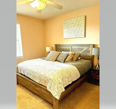 a bed sitting in a bedroom next to a window