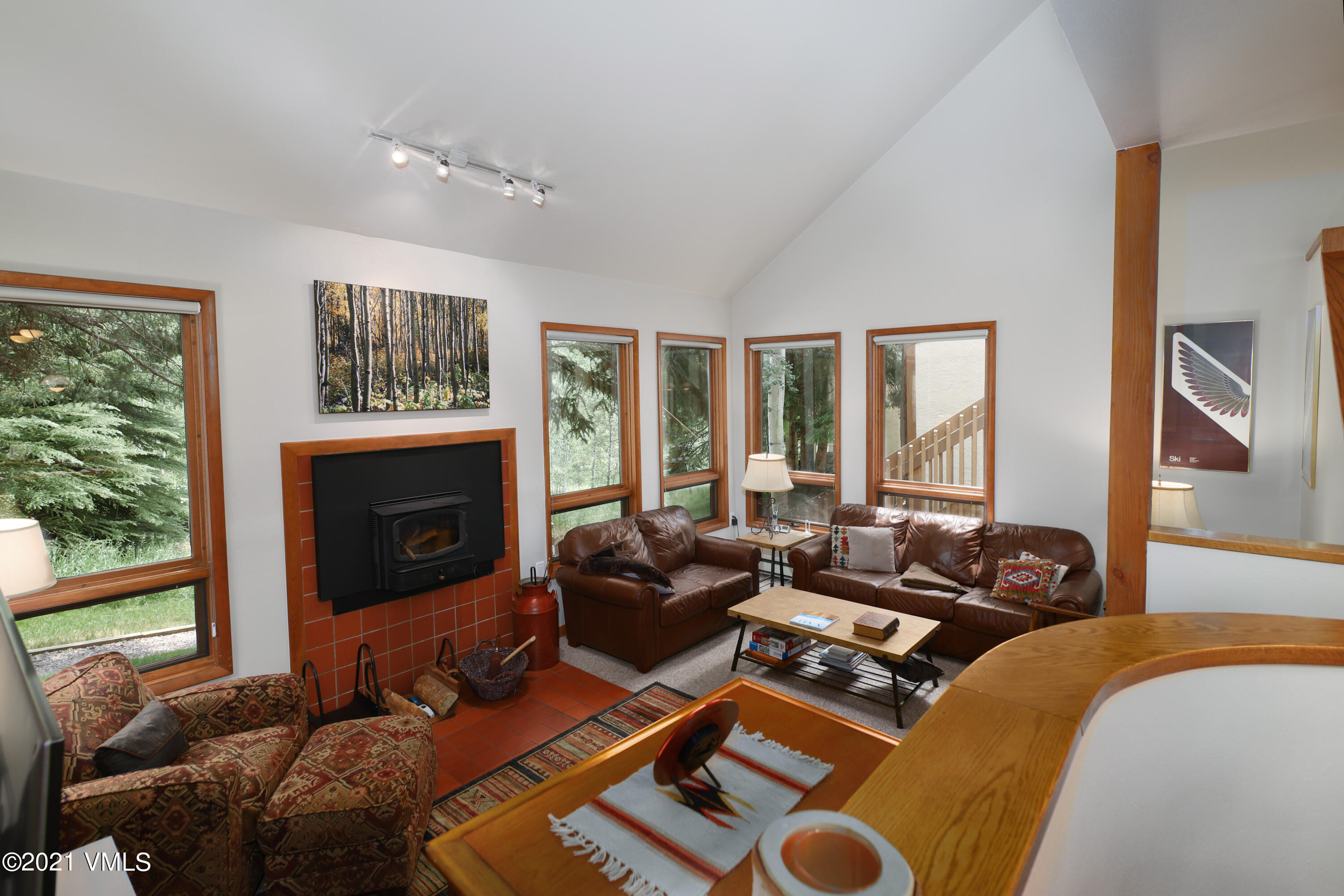 a living room with furniture a large window and a fireplace