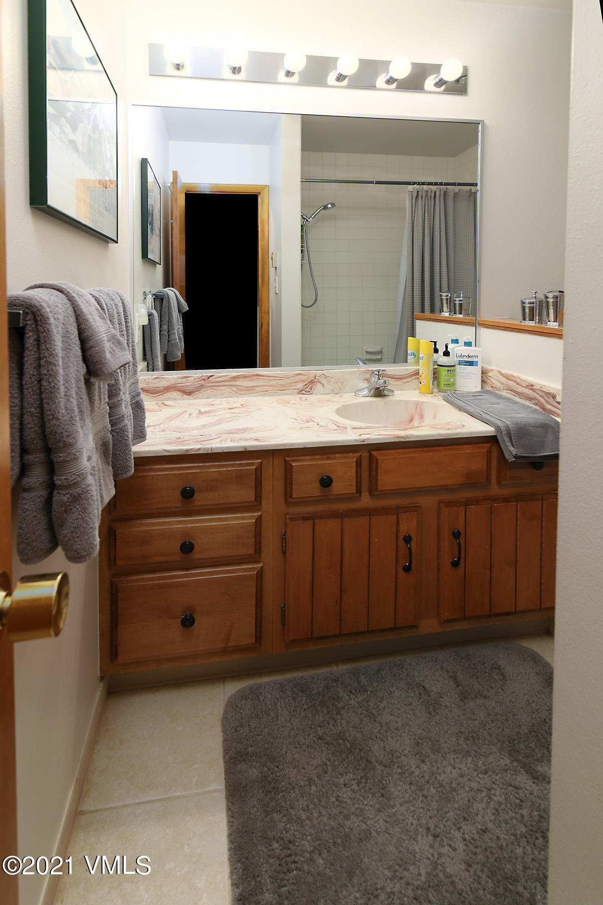 1480 Buffehr Creek Road, Unit 3A Vail, CO 81657 - Photo 11 of 17 a bathroom with a granite countertop sink and a mirror