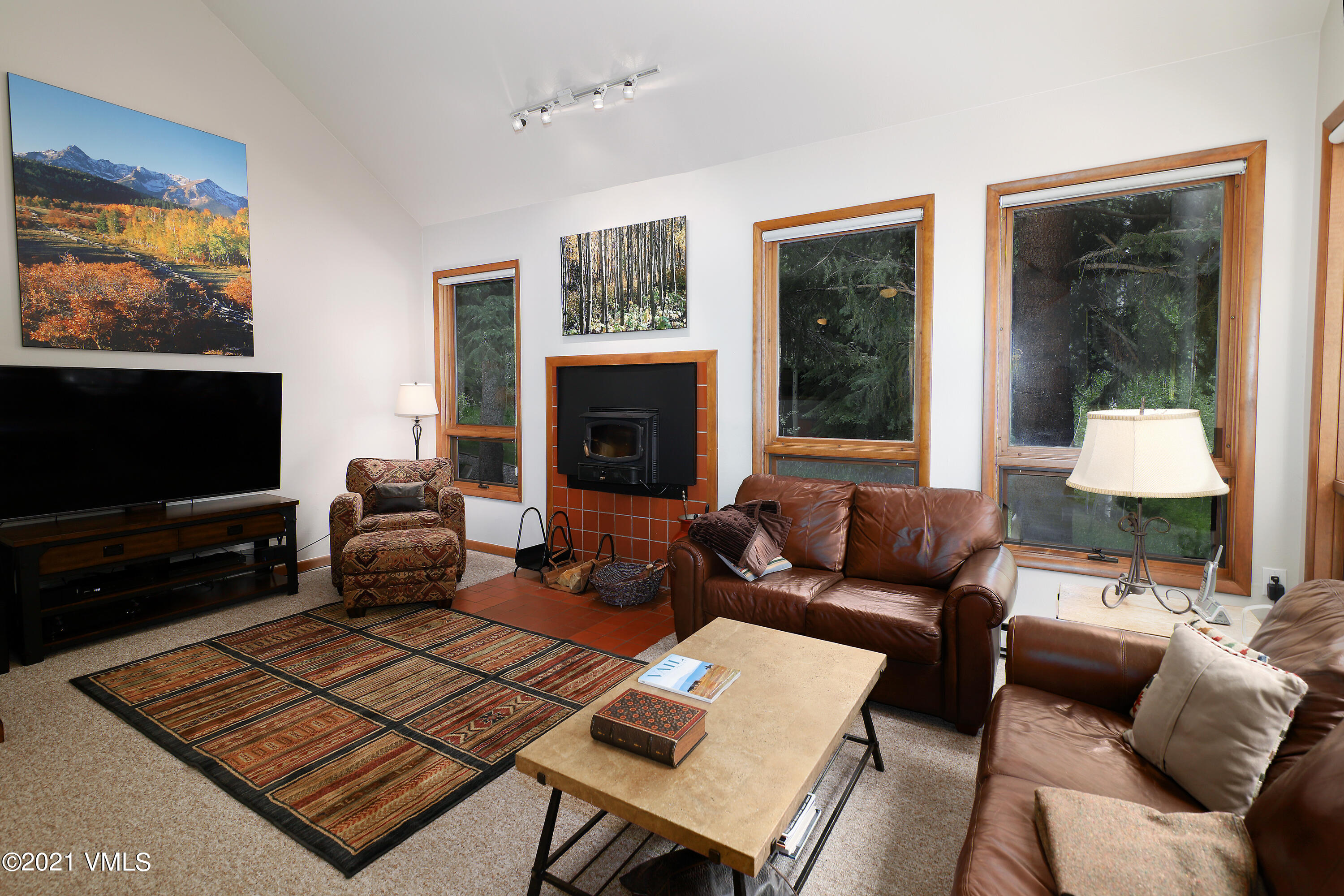 1480 Buffehr Creek Road, Unit 3A Vail, CO 81657 - Photo 2 of 17 a living room with furniture and a flat screen tv
