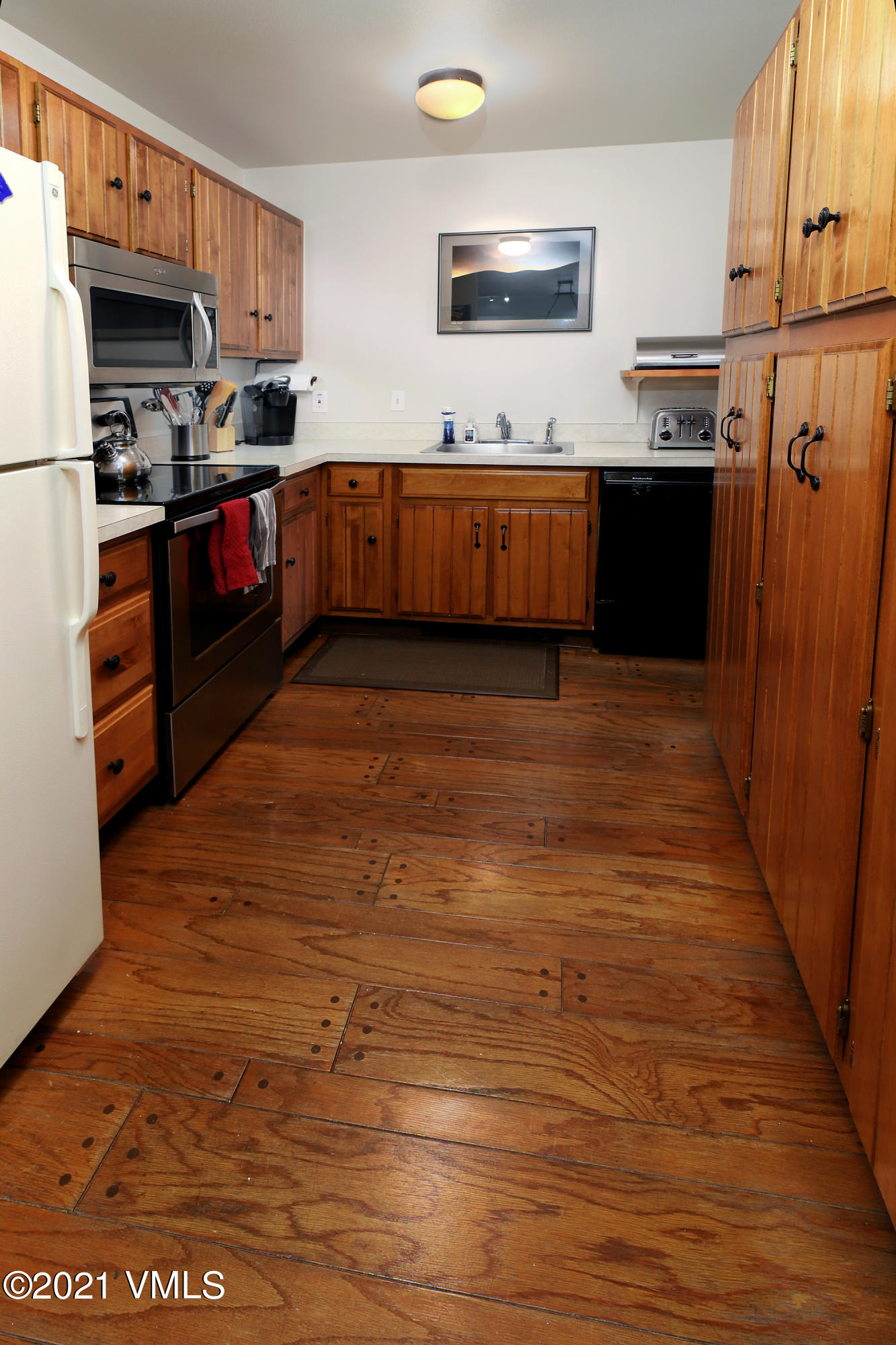 1480 Buffehr Creek Road, Unit 3A Vail, CO 81657 - Photo 4 of 17 a kitchen with stainless steel appliances granite countertop a stove a sink and a refrigerator
