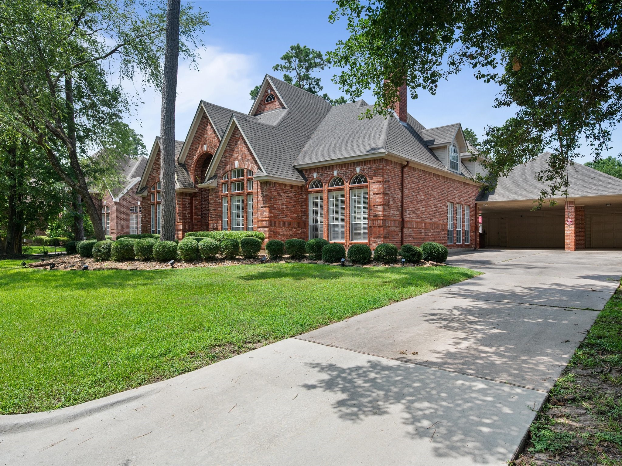16123 Lafone Drive Spring, TX 77379 - Photo 5 of 47 Beautifully manicured landscaping and an extended driveway create a welcoming approach while offering ample parking and convenience.