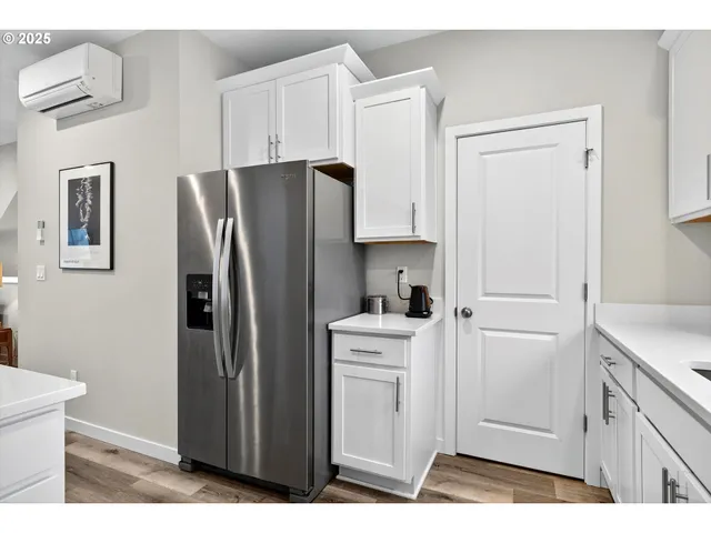 a kitchen with stainless steel appliances a refrigerator and cabinets