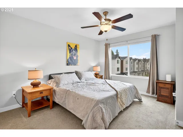 a bedroom with a bed and a large window