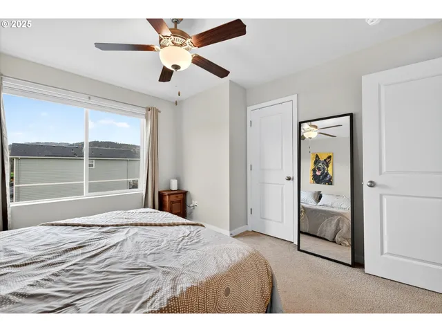 a bedroom with a bed and a large window