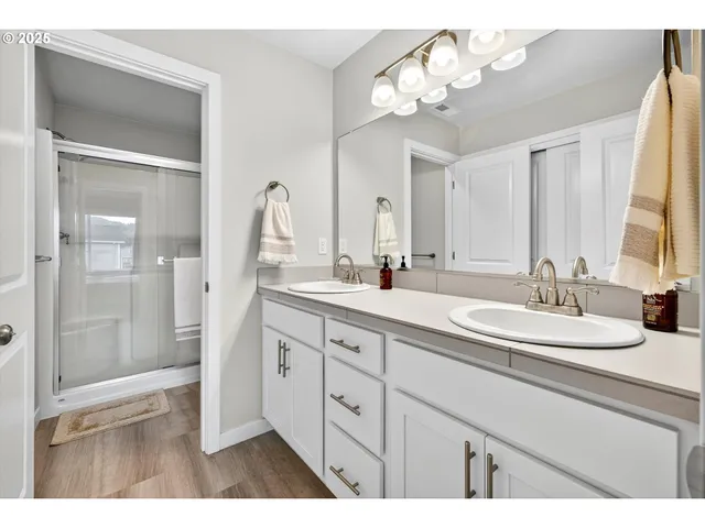 a bathroom with a double vanity sink and a mirror