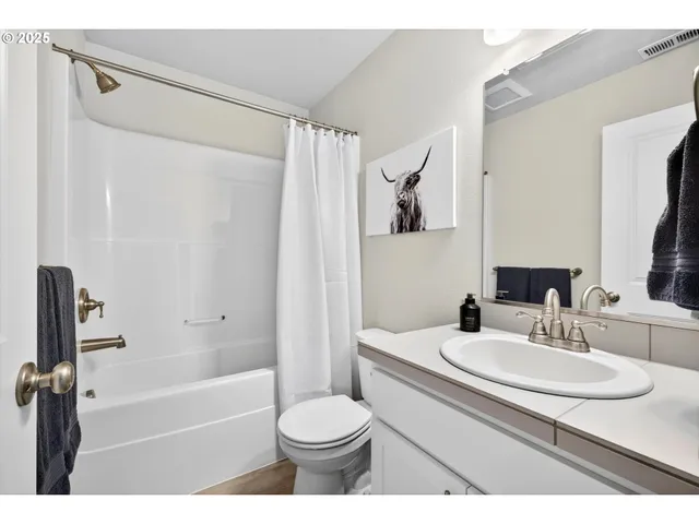 a bathroom with a sink toilet a mirror and shower