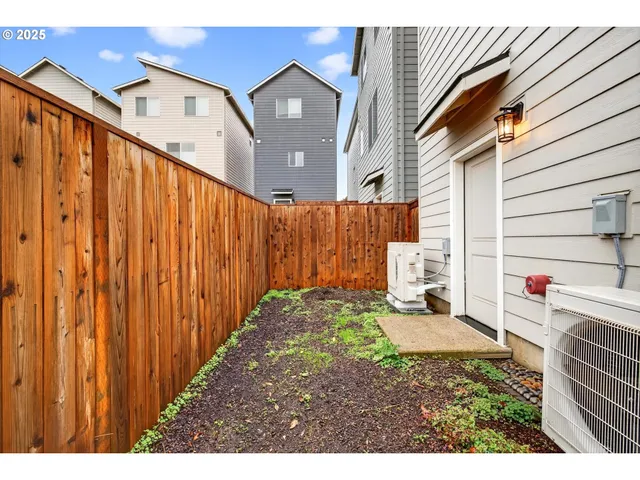 an aerial view of residential houses with outdoor space and parking