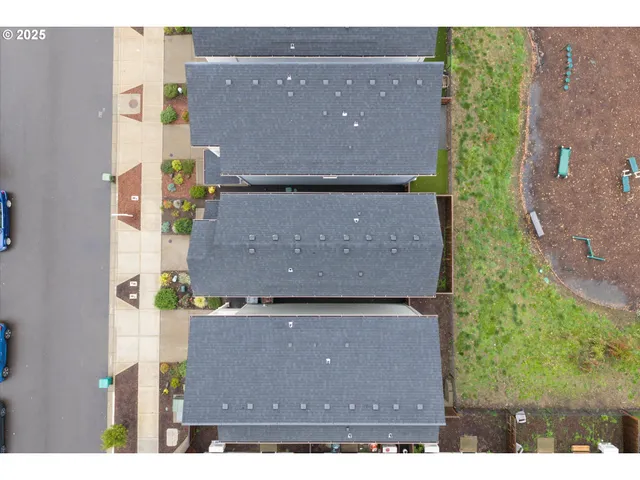 an aerial view of residential houses with outdoor space