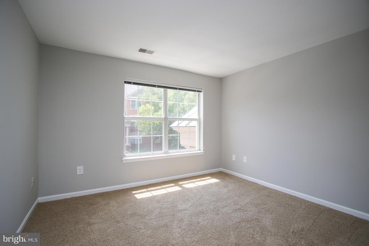402 Ridgepoint Place, Unit 28 Gaithersburg, MD 20878 - Photo 12 of 29 an empty room with a window