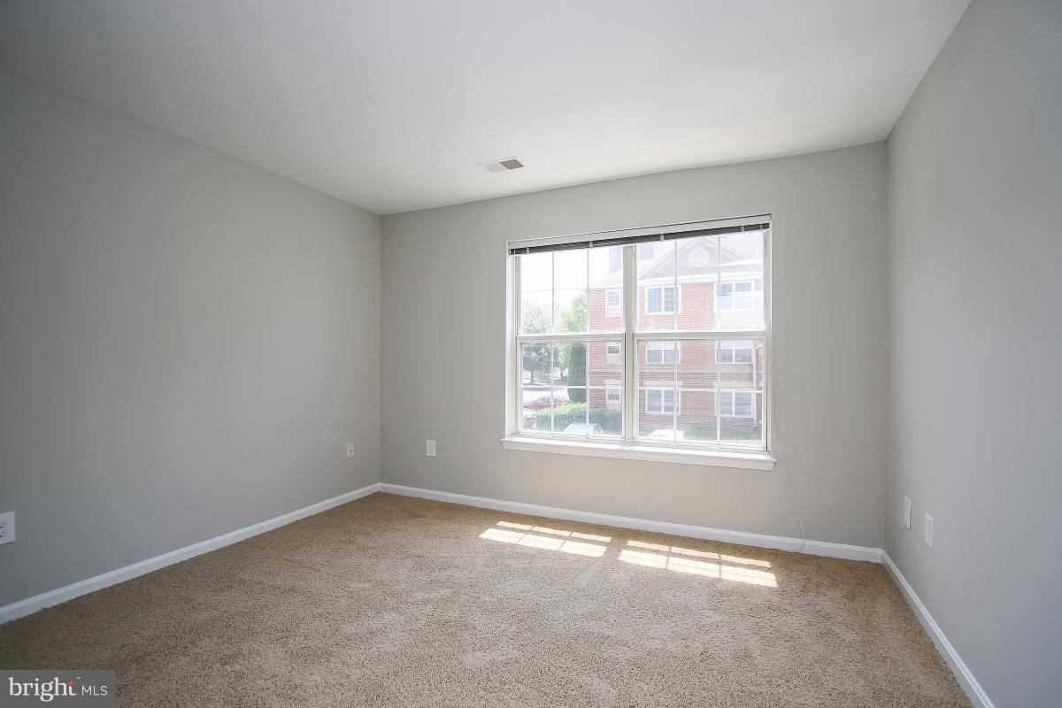 402 Ridgepoint Place, Unit 28 Gaithersburg, MD 20878 - Photo 13 of 29 an empty room with a window