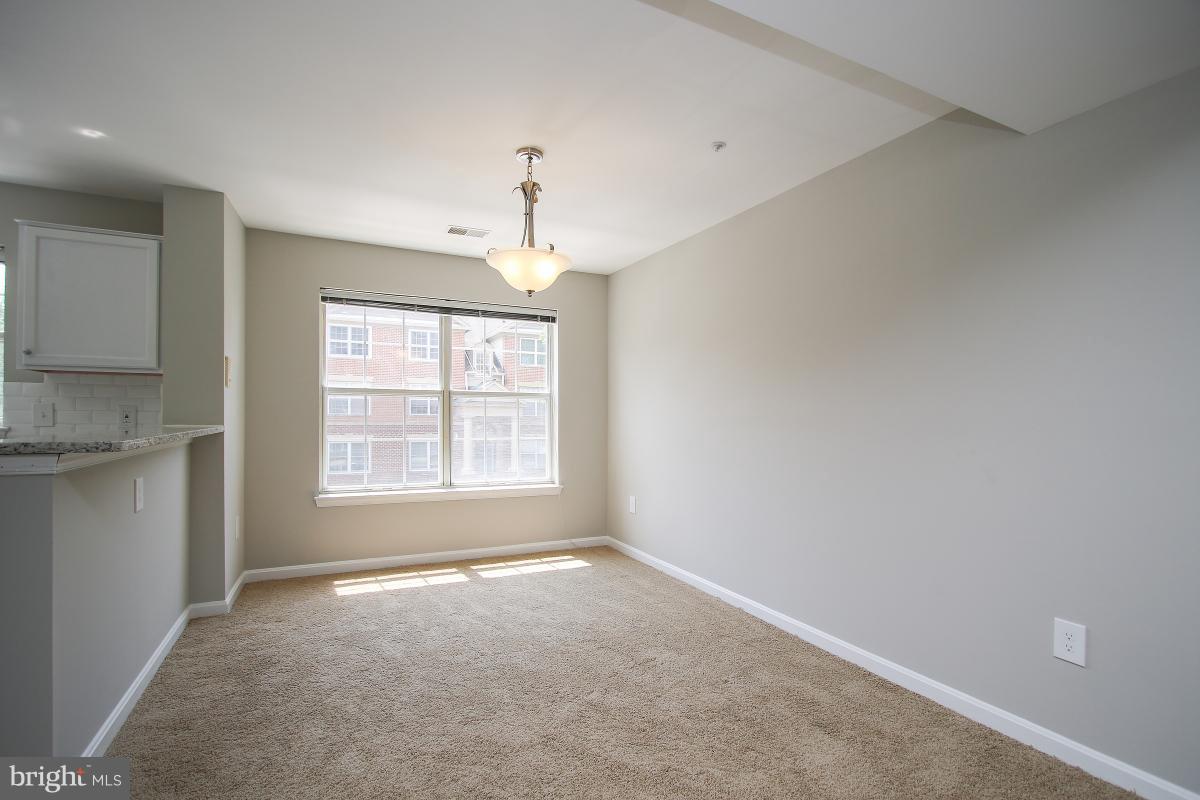 402 Ridgepoint Place, Unit 28 Gaithersburg, MD 20878 - Photo 6 of 29 a view of an empty room with a window