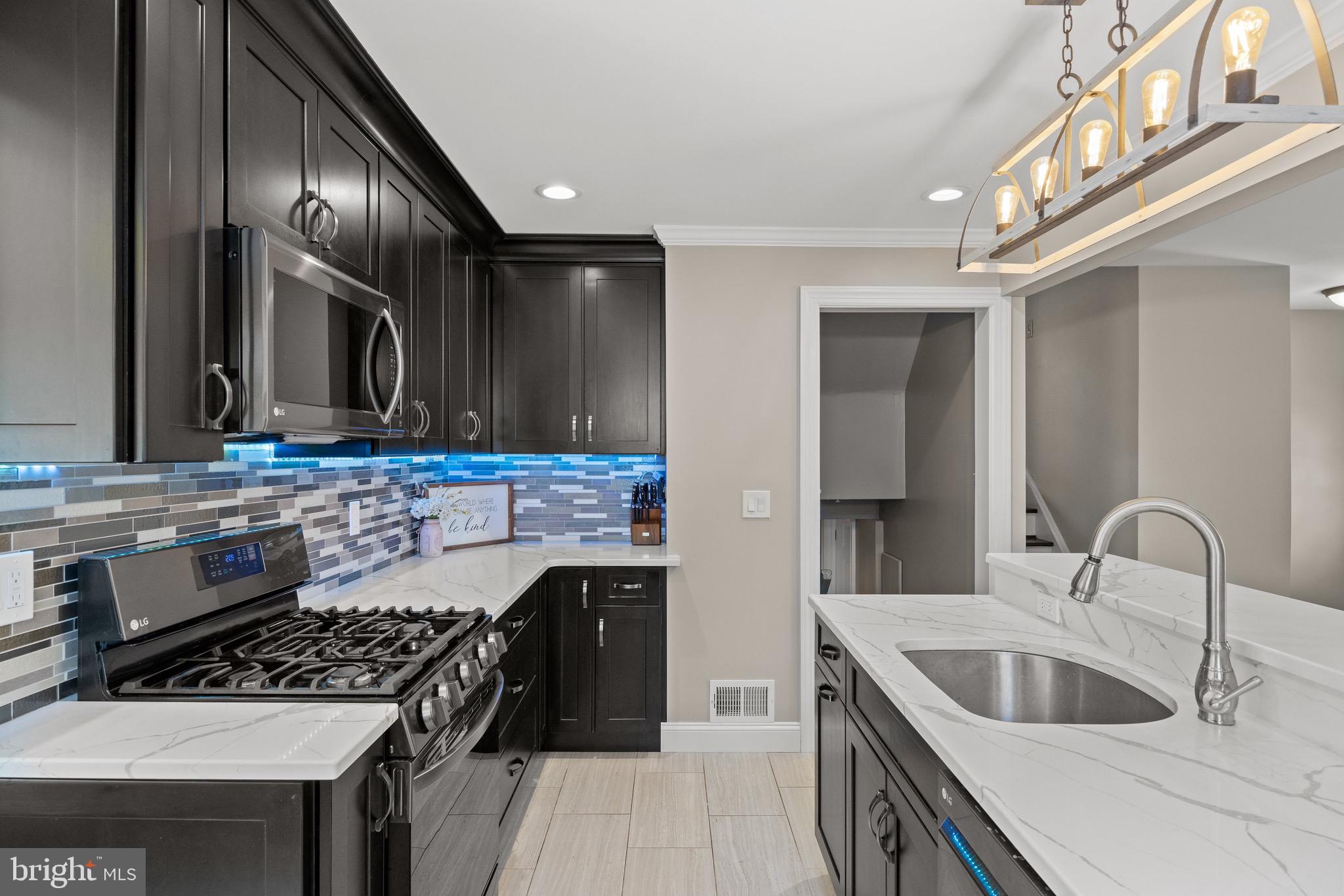 50 Miry Brook Road Hamilton, NJ 08690 - Photo 12 of 28 a kitchen with a stove and a sink