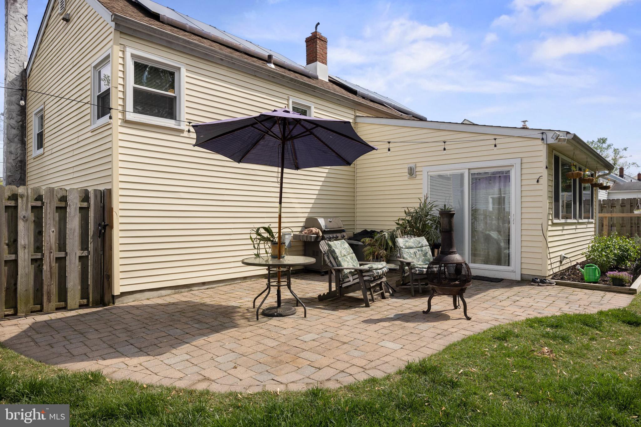 50 Miry Brook Road Hamilton, NJ 08690 - Photo 27 of 28 a roof deck with table and chairs under an umbrella