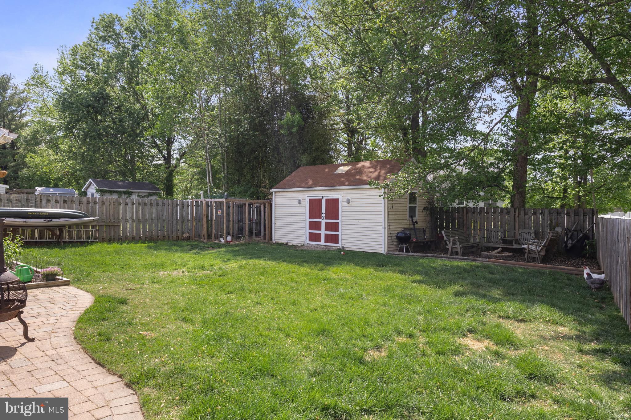 50 Miry Brook Road Hamilton, NJ 08690 - Photo 28 of 28 a view of a backyard with table and chairs and wooden fence