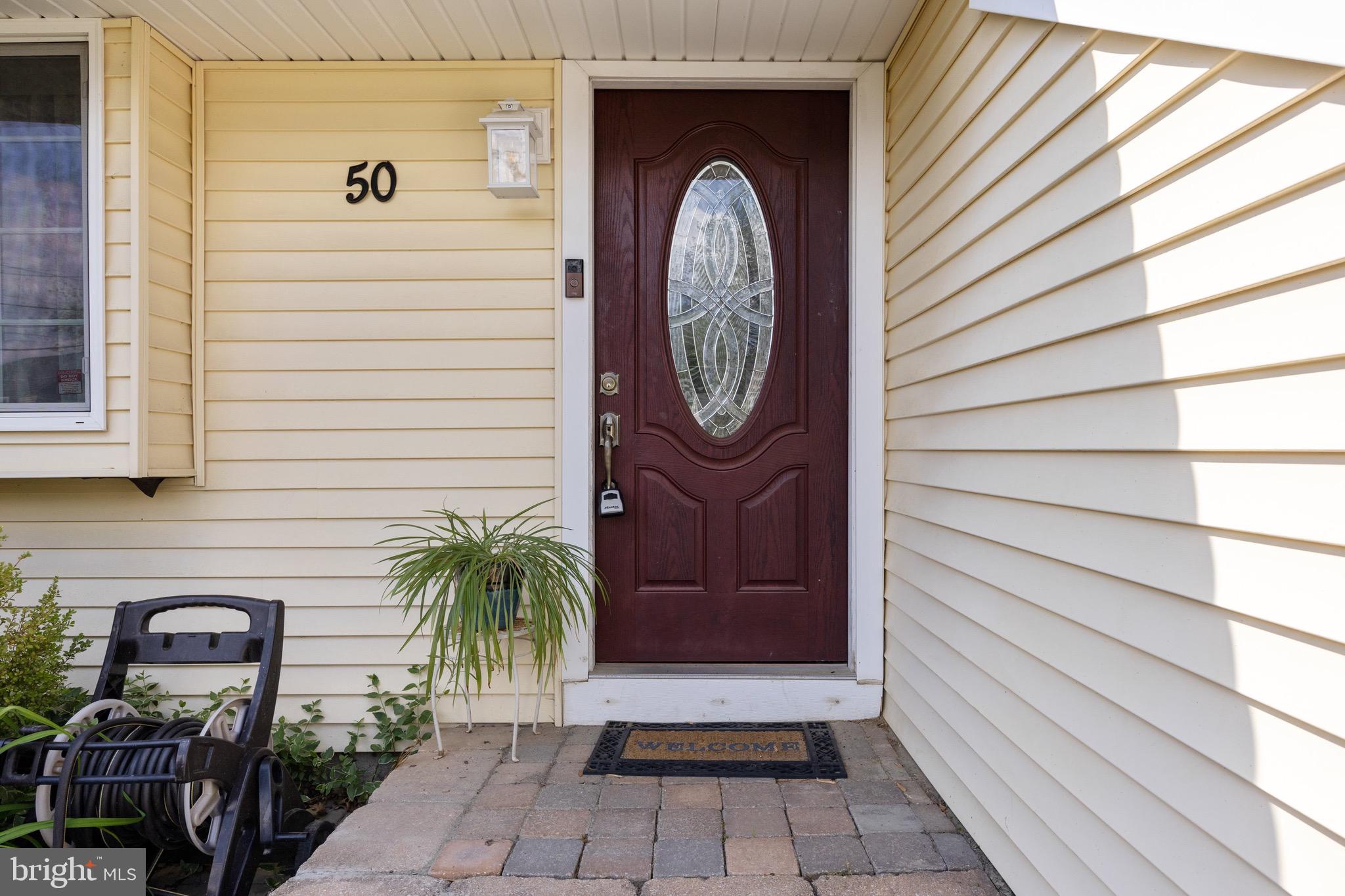 50 Miry Brook Road Hamilton, NJ 08690 - Photo 4 of 28 a view of a door of a house with potted plants