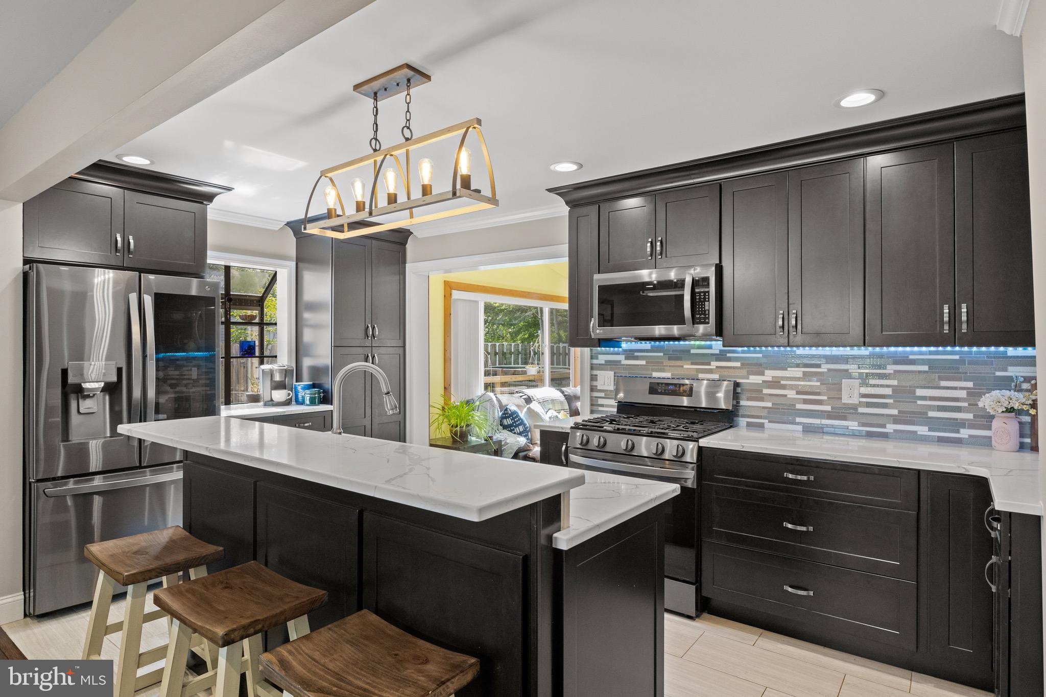 50 Miry Brook Road Hamilton, NJ 08690 - Photo 9 of 28 a kitchen with a sink stainless steel appliances and cabinets