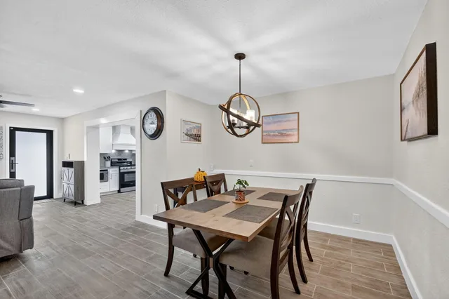 a view of a dining room with furniture wooden floor and a rug