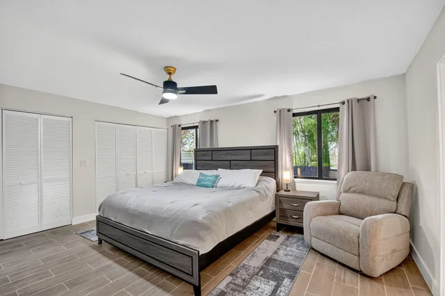 a bedroom with a bed couch and window