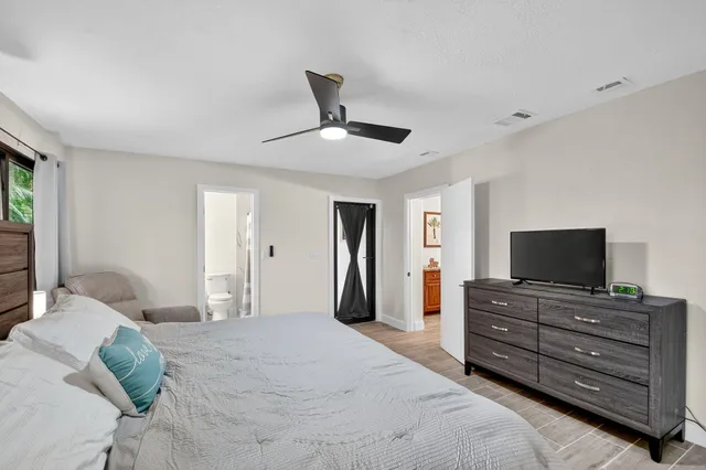 a bedroom with a bed and a flat screen tv