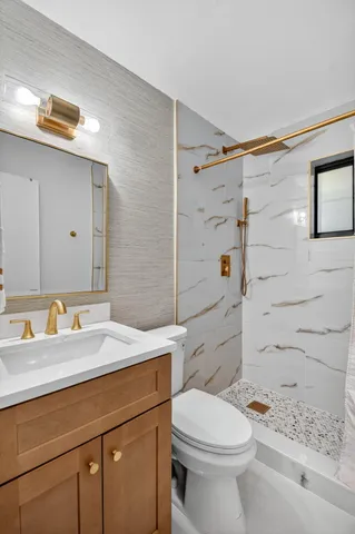 a bathroom with a sink toilet and shower
