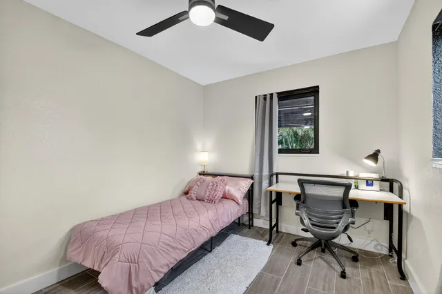 a bedroom with a bed and a desk