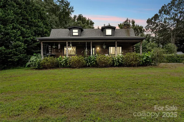 a front view of house with yard and trees