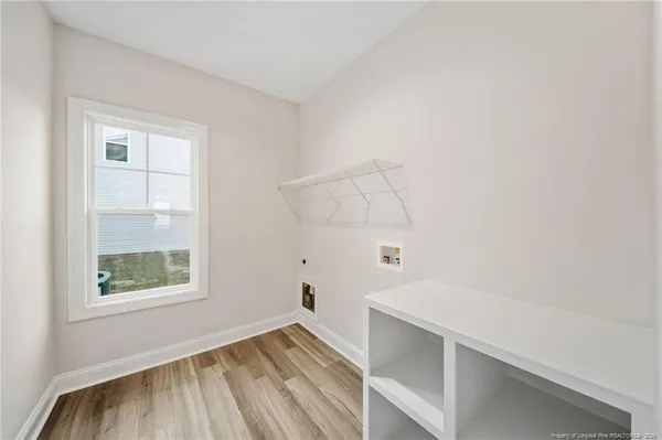 a view of room with window and wooden floor