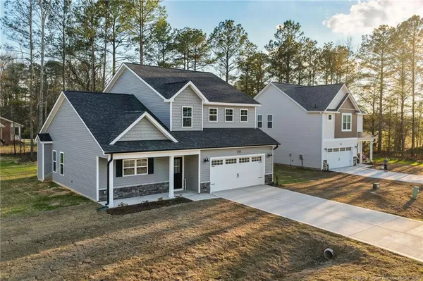 a house that has a tree in front of it