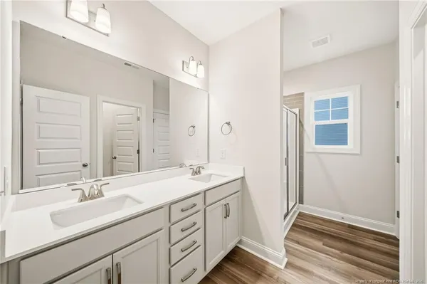 a bathroom with a sink double vanity and a mirror