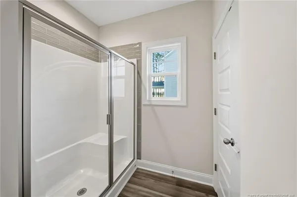 a bathroom with a glass shower door