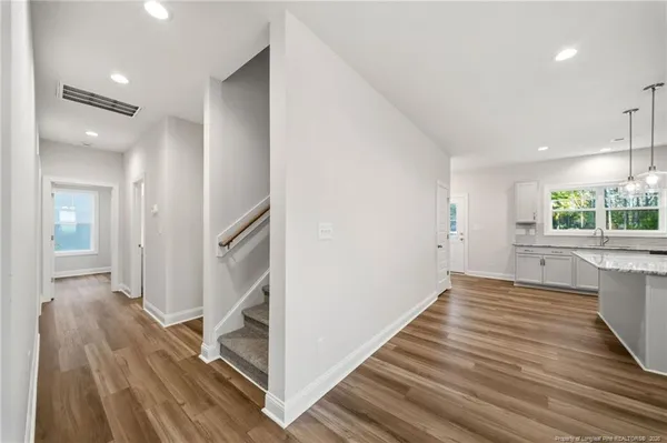 a view of a hallway view with wooden floor and staircase
