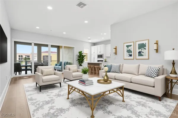a living room with furniture a rug and a large window