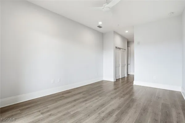a view of an empty room with wooden floor