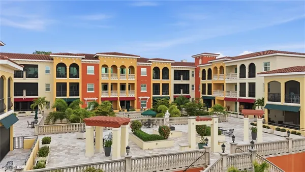 a front view of a building with balcony and seating space