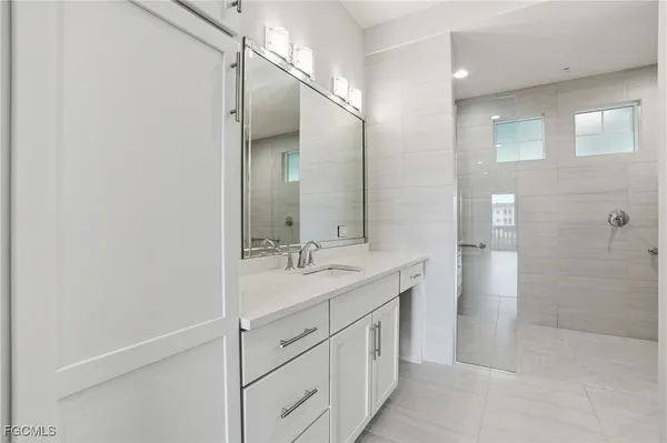 a bathroom with a granite countertop sink mirror and double