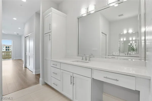 a bathroom with a double vanity sink a mirror and shower