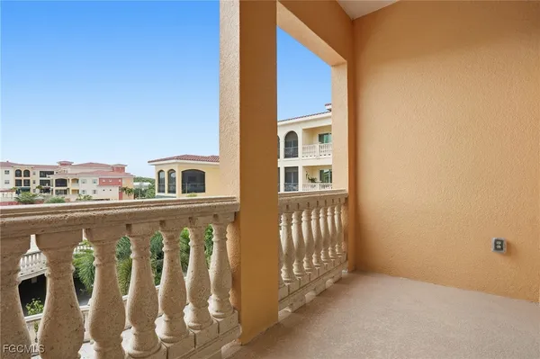 a balcony with wooden floor and fence