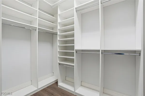 a view of walk in closet with empty racks