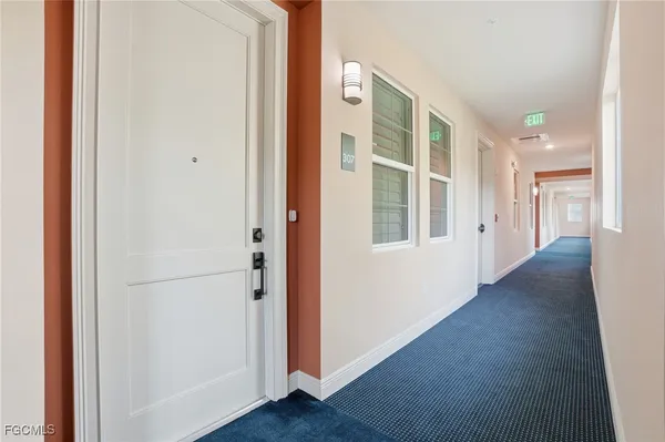 a view of a hallway with wooden floor and closet