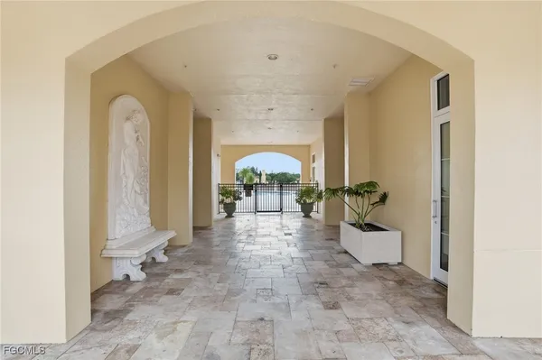 a view of a hallway with entryway windows and wooden floor