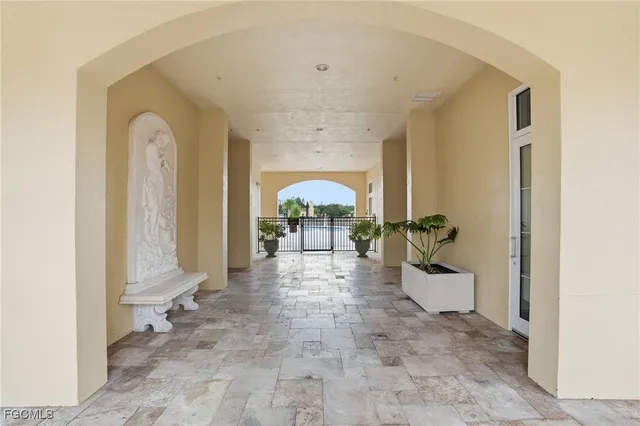 a view of a hallway with entryway windows and wooden floor