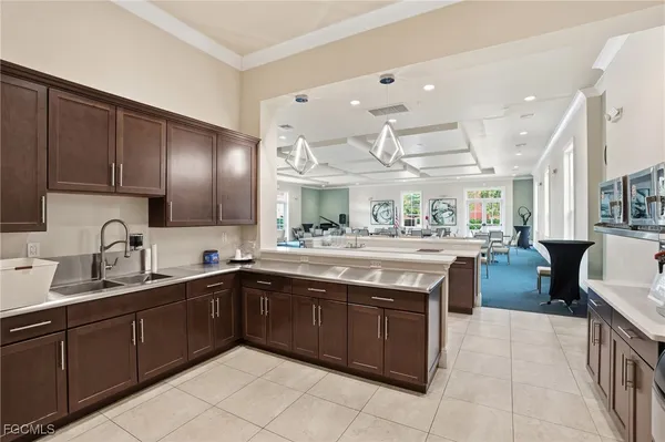 a kitchen with lots of counter top space sink and stainless steel appliances