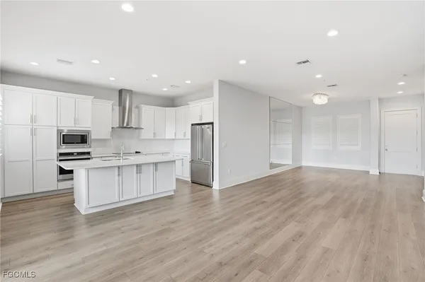 a kitchen with stainless steel appliances a refrigerator and cabinets