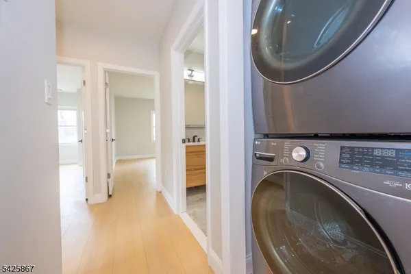 a view of a hallway with washer and dryer