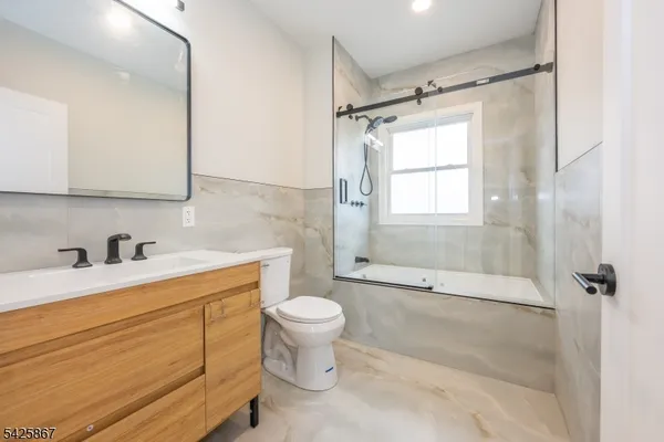 a bathroom with a sink toilet and shower