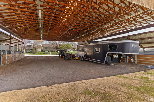 5321 South 3100th Street West Roy, UT 84067 - Photo 13 of 64 Spacious covered equestrian facility featuring multiple stalls with wood and metal construction